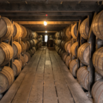 whiskey barrels aging in warehouse