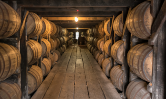 whiskey barrels aging in warehouse