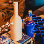 sotol bottle and blue porcelain tumblers