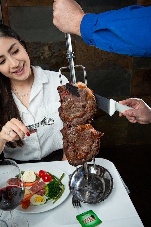 The rodizio-style service of all-you-can-eat grilled meats at Brazilian steakhouse Galpao Gaucho