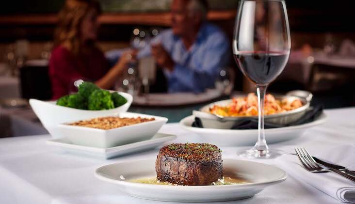 Steak and glass of red wine at Ruth’s Chris Steak House