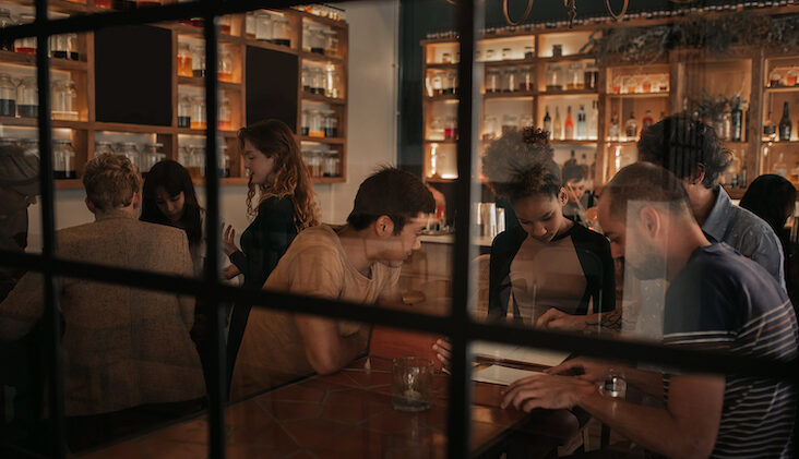 People looking at menus in a bar