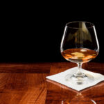 Brandy snifter on a wood bar top