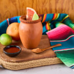 Refreshing cantaritos with tequila and lime, cocktail from mexico in a mug clay